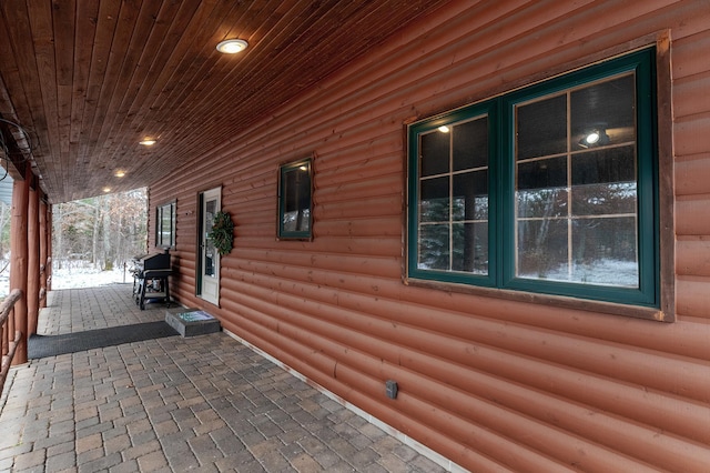 view of side of property featuring covered porch