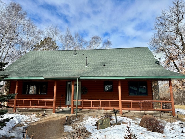 view of front of house with a porch and a shingled roof