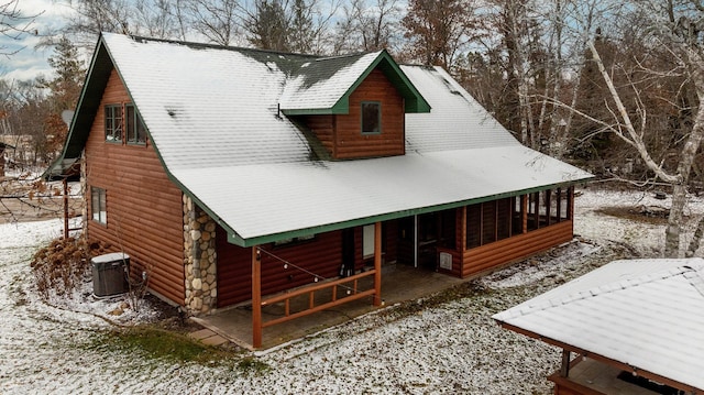 view of front of house with a sunroom and central AC unit