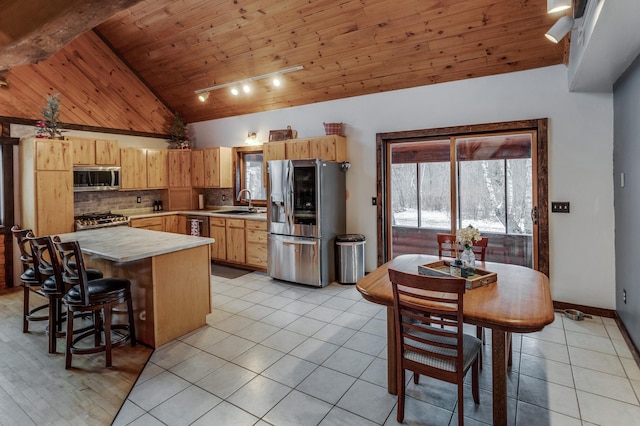 kitchen with light tile patterned floors, tasteful backsplash, wood ceiling, stainless steel appliances, and light countertops