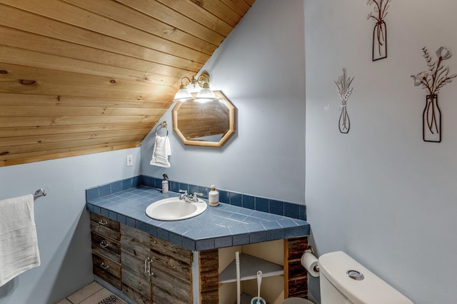 half bathroom featuring toilet, wooden ceiling, vanity, and lofted ceiling