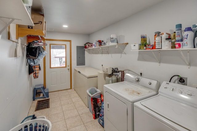 laundry room featuring light tile patterned floors, laundry area, electric panel, and separate washer and dryer