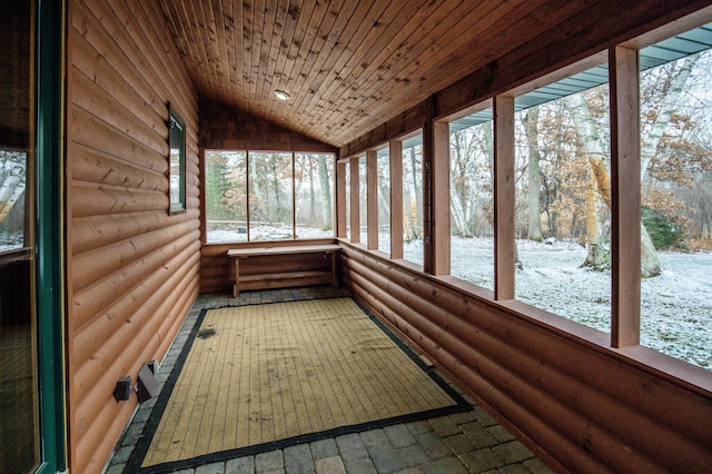 unfurnished sunroom with a healthy amount of sunlight, wooden ceiling, and lofted ceiling