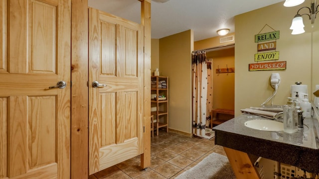 bathroom with tile patterned floors, vanity, and a shower with shower curtain