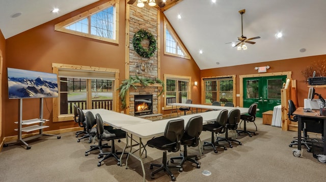 interior space with high vaulted ceiling, a ceiling fan, and a fireplace