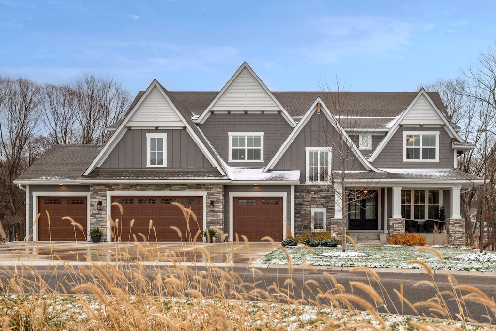 craftsman inspired home featuring a porch and a garage