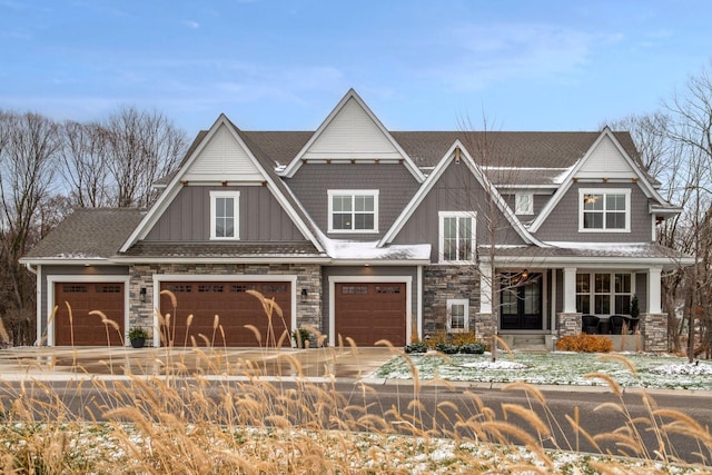 craftsman inspired home featuring a porch and a garage