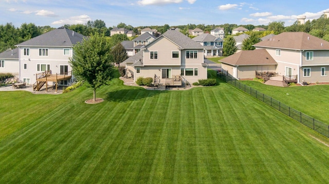 rear view of property featuring a lawn