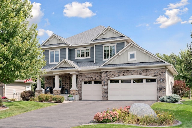 craftsman-style house featuring a porch, a garage, and a front lawn