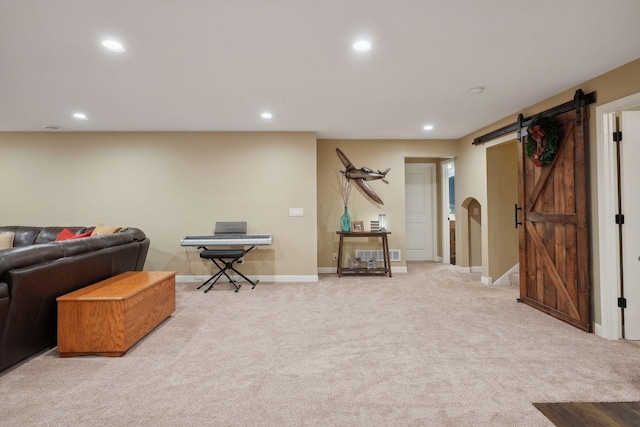 carpeted living room featuring a barn door