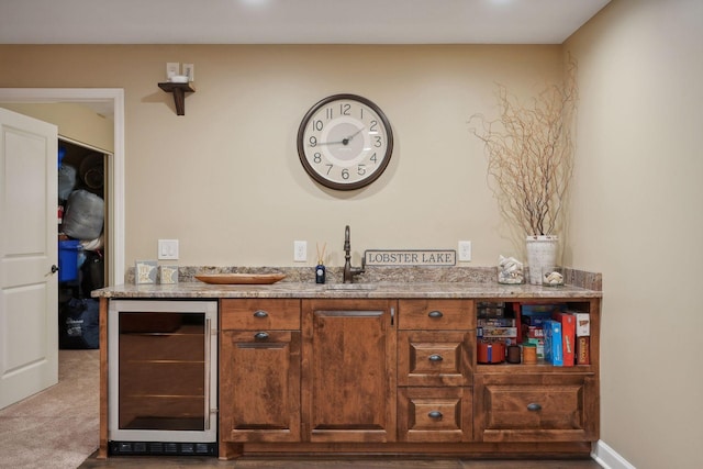 bar featuring carpet, beverage cooler, and sink