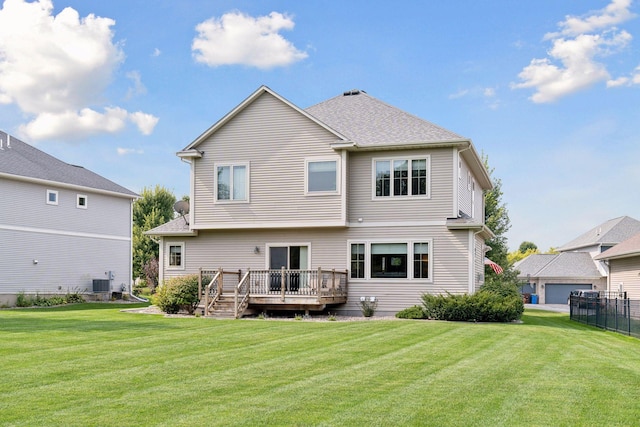 rear view of property with a wooden deck, a yard, and central AC unit