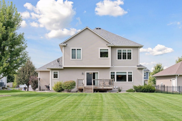 back of property with central air condition unit, a yard, and a deck