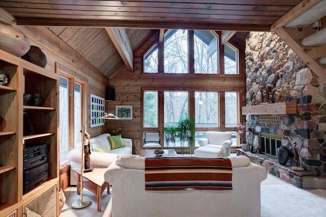 living room with vaulted ceiling with beams, plenty of natural light, wooden ceiling, and a fireplace