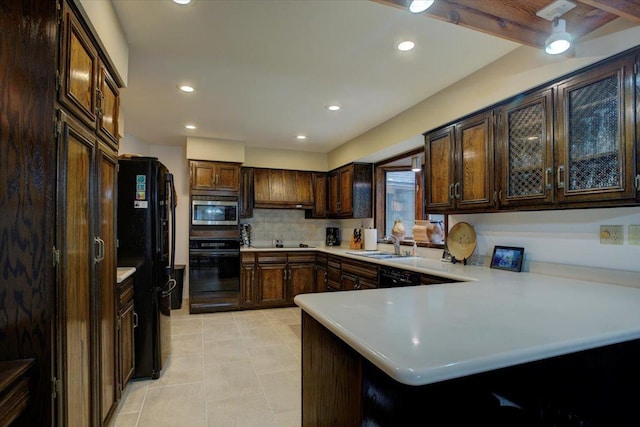 kitchen with black appliances, light tile patterned floors, tasteful backsplash, a kitchen bar, and kitchen peninsula