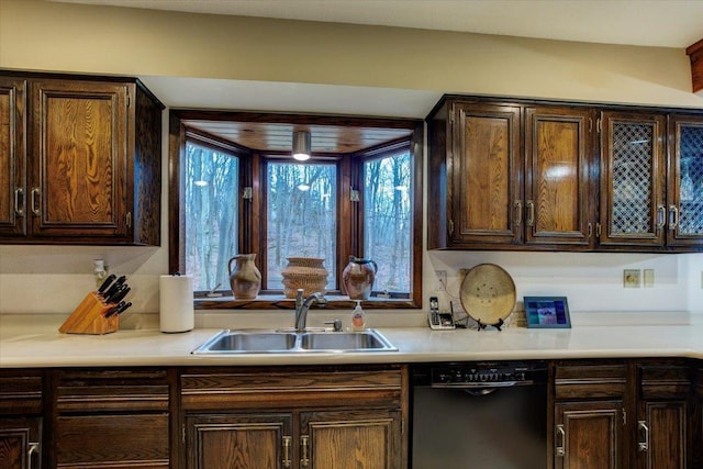 kitchen featuring dark brown cabinetry, sink, and black dishwasher