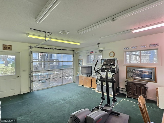 workout room with a textured ceiling and baseboard heating