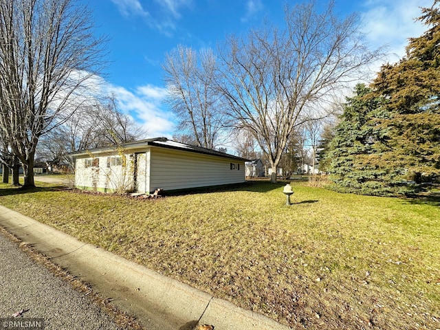 view of property exterior with a lawn