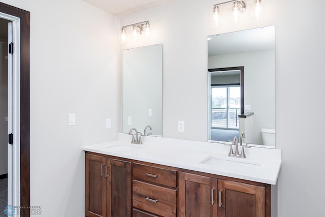 bathroom featuring vanity and toilet