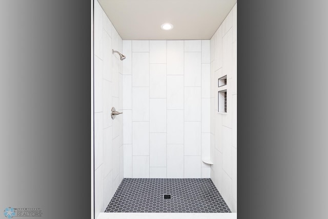 bathroom with tiled shower