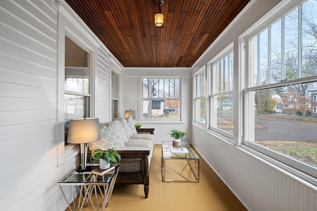 sunroom / solarium featuring a healthy amount of sunlight and wooden ceiling