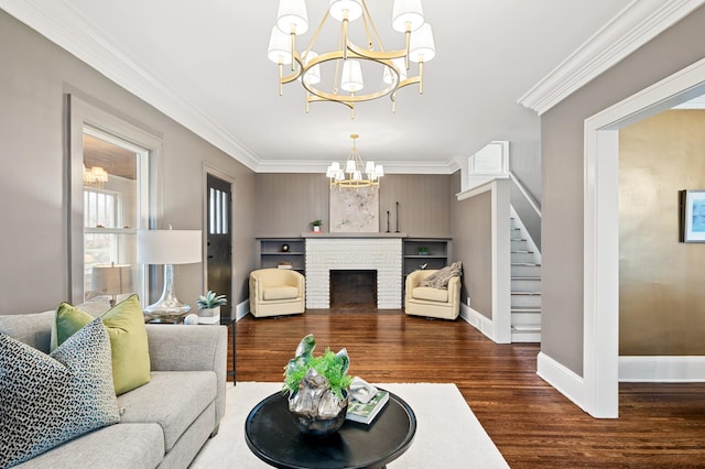 living room with a fireplace, an inviting chandelier, crown molding, and dark wood-type flooring