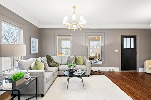 living room with light hardwood / wood-style flooring, a chandelier, and ornamental molding