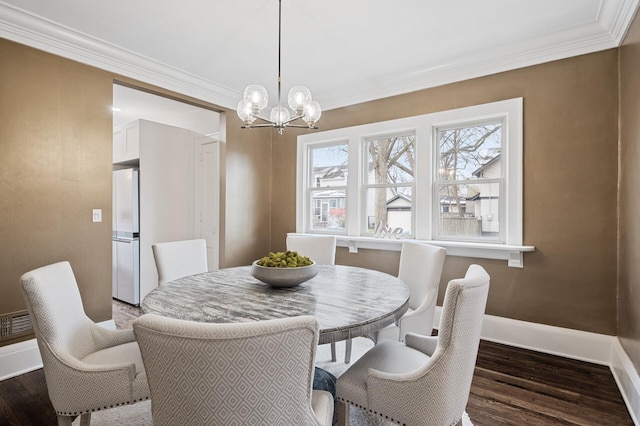 dining room featuring ornamental molding, dark wood-type flooring, and a notable chandelier