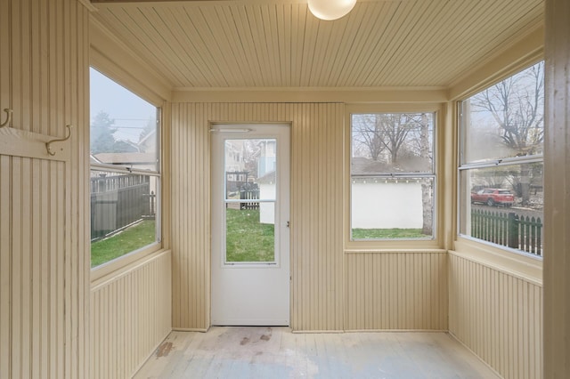 unfurnished sunroom featuring wood ceiling