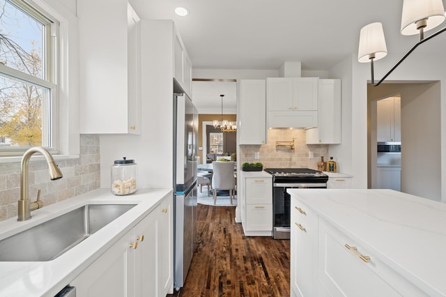 kitchen featuring white cabinetry, plenty of natural light, and stainless steel appliances