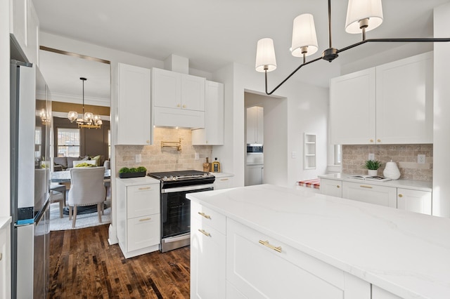 kitchen featuring white cabinets, backsplash, dark hardwood / wood-style flooring, and stainless steel appliances