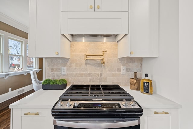 kitchen with white cabinets, dark hardwood / wood-style flooring, and stainless steel range oven