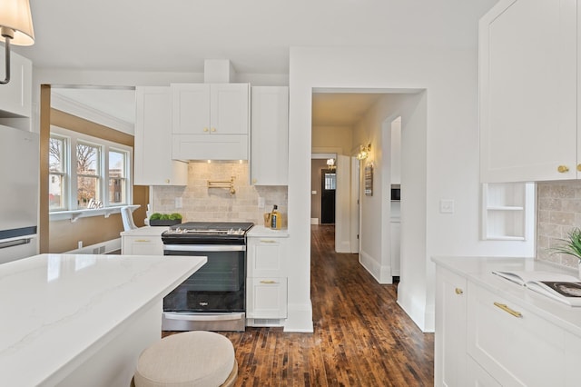 kitchen with backsplash, dark hardwood / wood-style floors, white cabinetry, and stainless steel electric range