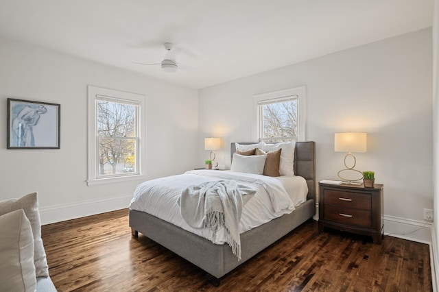 bedroom with multiple windows, ceiling fan, and dark wood-type flooring