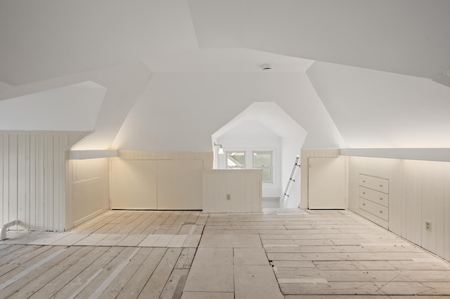 bonus room featuring lofted ceiling and light hardwood / wood-style flooring