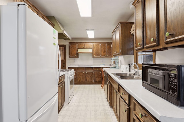 kitchen featuring white appliances and sink