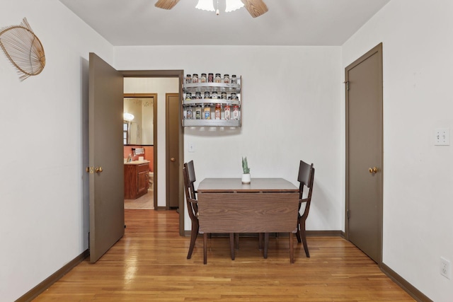 dining area with light wood-type flooring and ceiling fan