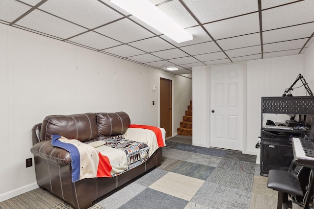 interior space with dark colored carpet and a drop ceiling