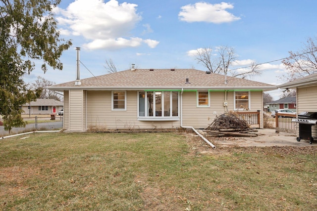 rear view of property featuring a yard