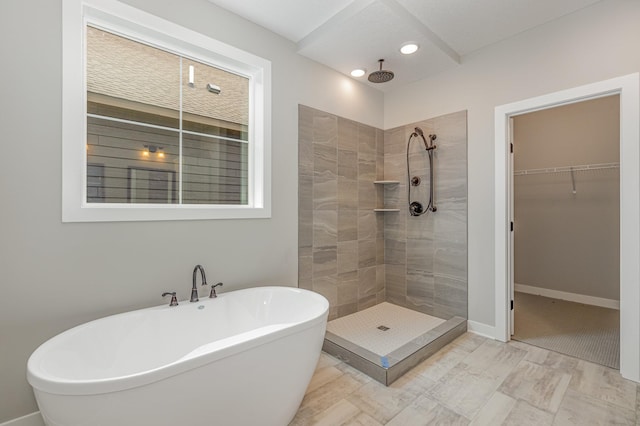 bathroom featuring shower with separate bathtub