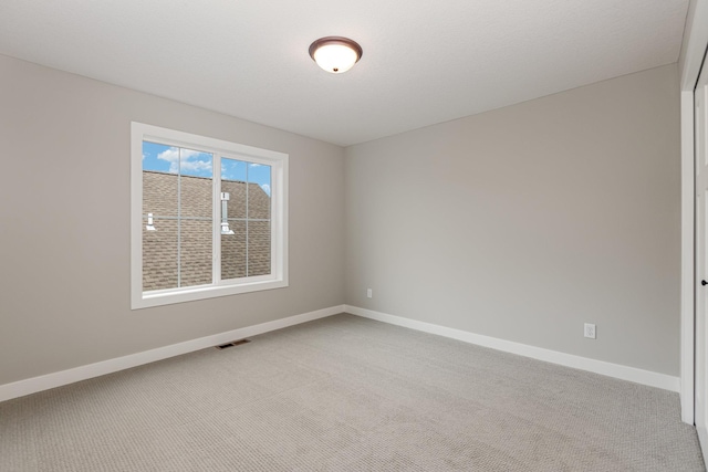 empty room with light colored carpet