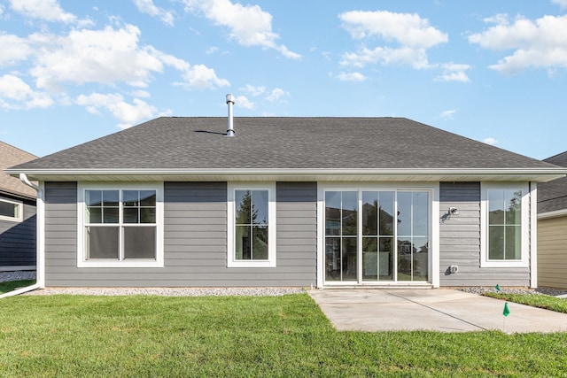 back of house featuring a patio and a lawn