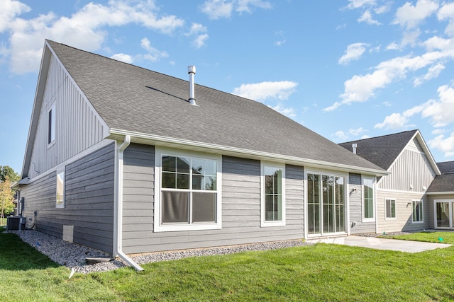 rear view of property featuring central AC, a yard, and a patio