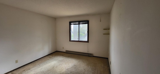 carpeted spare room with a textured ceiling and a baseboard radiator