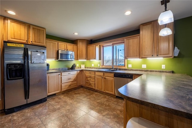 kitchen featuring pendant lighting, stainless steel appliances, and sink