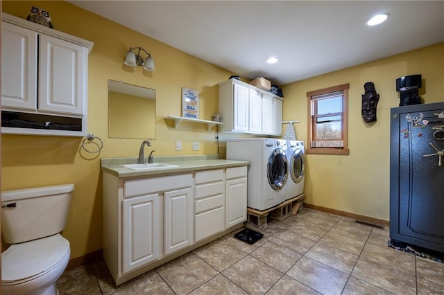 washroom featuring sink, light tile patterned flooring, and washer and dryer