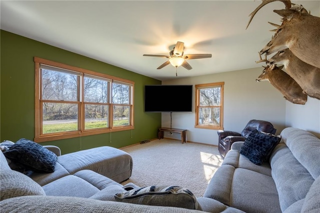 living room with ceiling fan and light colored carpet