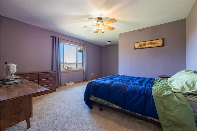 bedroom featuring ceiling fan and light carpet