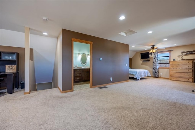 unfurnished bedroom featuring connected bathroom and light carpet