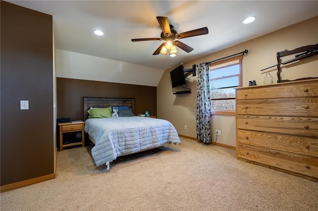 bedroom with light carpet, vaulted ceiling, and ceiling fan